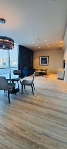 a living room with a couch and a table and chairs at One bedroom apartment - DAMAC TOWER in Riyadh