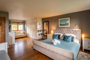 a bedroom with a large bed with blue pillows at Portbahn, Bruichladdich in Bruichladdich