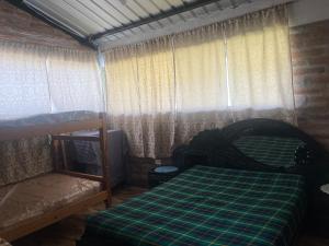 a bedroom with a bed and two bunk beds at Casa de Campo en Zuleta in Huamboya