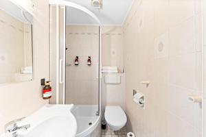 a bathroom with a shower and a toilet and a sink at Flora Collection in Vienna