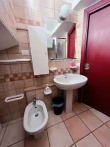 a bathroom with a toilet and a sink at Above The Sky - Flying Apartment in San Marino