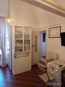 eine Küche mit einem Tisch und einem weißen Schrank in der Unterkunft Locazione turistica La vecchia arcata in Noci