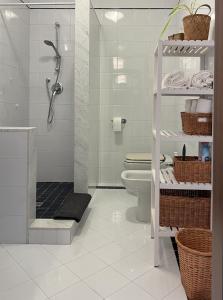 een witte badkamer met een douche en een toilet bij Crestudio Stanza accogliente vicino al Ponte Vecchio in Bassano del Grappa