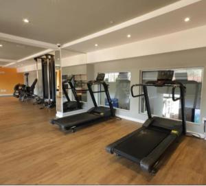 a gym with a row of exercise bikes in a room at HotBeachSuites Lazer e Diversão in Olímpia