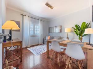 a living room with a dining room table and chairs at Olaias Lisbon 2bed near Metro in Lisbon