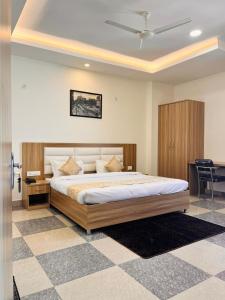 a bedroom with a large bed and a desk at Silver Bliss in Lucknow