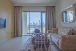 a living room with a couch and a tv at BellaVista Chic 2 BR Downtown View II T1 - Burj Khalifa View in Dubai