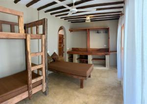 a room with two bunk beds and a ceiling at Lapili Residence Apartments in Kiwengwa