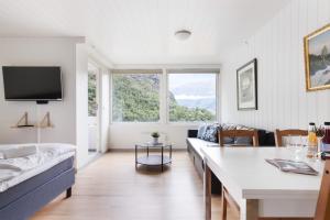 a living room with a couch and a table at Trolltunga Aparthotel in Tysso