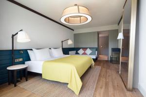 a hotel room with a large bed and a table at Voyage Belek Golf & Spa Hotel in Belek