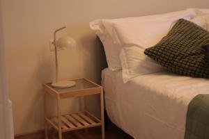 a bed with a lamp on a table next to it at B&B La Casetta in Cambiago
