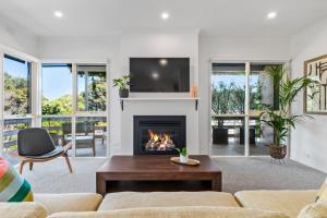 a living room with a fireplace and a tv at Hampton Vintage Soul with Pool in Melbourne