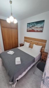 a bedroom with a large white bed with a ceiling at Marina Apartments - Valentin in Santa Pola