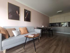 a living room with a couch and a table at Apartamenty Tychy Kopernika in Tychy