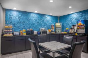 a dining room with a table and a counter with aperature at Days Inn by Wyndham Lonoke in Lonoke