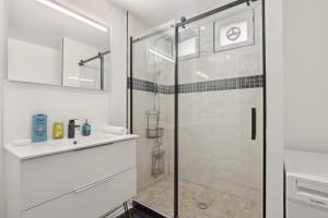 a white bathroom with a shower and a glass door at Chic and spacious apartement with piano and terrace in Le Chesnay +20 photos
