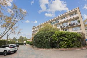 a white car parked in front of a building at Chic and spacious apartement with piano and terrace in Le Chesnay