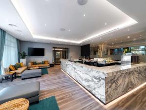 a lobby with a bar and a living room at Sofitel Dubai The Palm Resort & Spa in Dubai