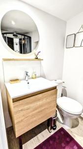 uma casa de banho com um lavatório e um WC em A la ville comme à la campagne em Sainte-Savine