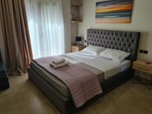 a bedroom with a large bed with a pink blanket at Fay's luxury loft in Volos