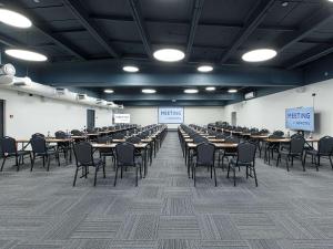 a large room with tables and chairs in it at Novotel Vladivostok in Vladivostok