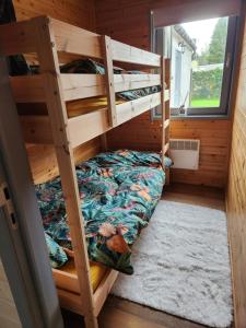 a bedroom with bunk beds in a tiny house at LE GLAWAN in Barvaux