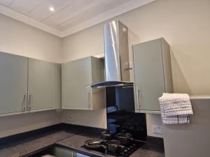 a kitchen with white cabinets and a stove top oven at Levy Nook 4 in Darlington