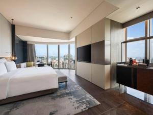 Voodi või voodid majutusasutuse Pullman Quanzhou Shuitou toas