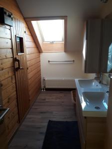 ein Bad mit einem Waschbecken und einem Fenster in der Unterkunft Hinterramsebn in Vorderstoder