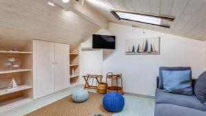 a living room with a couch and a tv and shelves at Glamorous 1 BDR Duplex Apartment by LovelyStay in Tavira