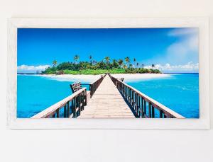 a boardwalk to a tropical island in the ocean at Calabria Experience **** in Montegiordano