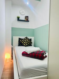 a bed in a room with a mirror at Flexible Small Partition Room Near MOE in Dubai