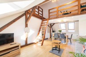 a room with a loft bed and a dining room with a table at Apartment with Entresol Old Town Krakow in Krakow