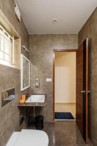 a bathroom with a sink and a mirror at SpringPetals Serviced Apartments in Bangalore