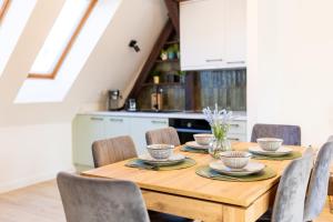 a dining room table with chairs and a kitchen at Apartment with Entresol Old Town Krakow in Krakow