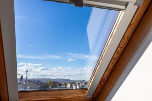 a window with a view of the city at Apartment with Entresol Old Town Krakow in Krakow