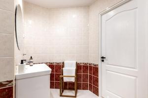 a bathroom with a white sink and a mirror at Apartment with Entresol Old Town Krakow in Krakow