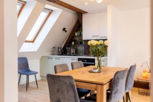 a kitchen and dining room with a wooden table and chairs at Apartment with Entresol Old Town Krakow in Krakow