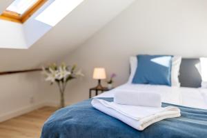 a bedroom with a bed with a towel on it at Apartment with Entresol Old Town Krakow in Krakow