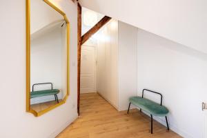 a room with a mirror and a green chair at Apartment with Entresol Old Town Krakow in Krakow