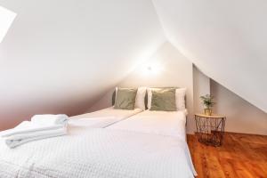 a bedroom with two beds in a attic at Apartment with Entresol Old Town Krakow in Krakow