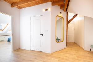 a room with a white door and a mirror at Apartment with Entresol Old Town Krakow in Krakow
