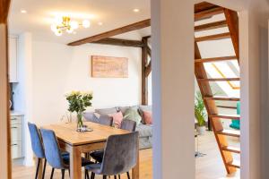 a dining room with a wooden table and blue chairs at Apartment with Entresol Old Town Krakow in Krakow