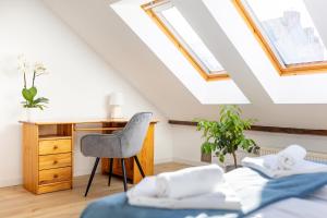 a attic bedroom with a desk and a chair at Apartment with Entresol Old Town Krakow in Krakow