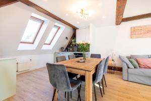 a kitchen and dining room with a wooden table and chairs at Apartment with Entresol Old Town Krakow in Krakow