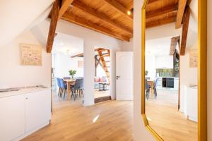 a kitchen and dining room with white cabinets and wooden ceilings at Apartment with Entresol Old Town Krakow in Krakow