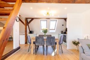 a kitchen and dining room with a table and chairs at Apartment with Entresol Old Town Krakow in Krakow
