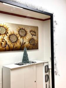 a mirror in a room with a picture of sunflowers at Spacious Master Suite in Seoul