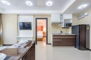 a kitchen with a counter top in a room at Modern MBC condo near the beach in Ban Bo Sai Klang