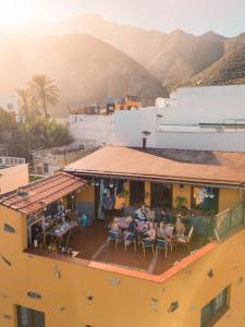 a group of people sitting on a balcony of a building at Casanaga in Almáciga